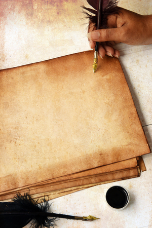 old paper on brown wood texture with feather and ink.の写真素材