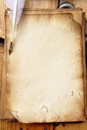 old paper on brown wood texture with pen for backgroundの写真素材
