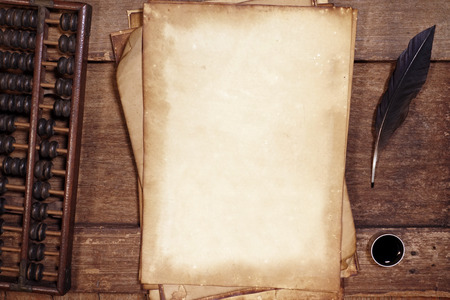 old paper on brown wood texture with feather and ink.の写真素材