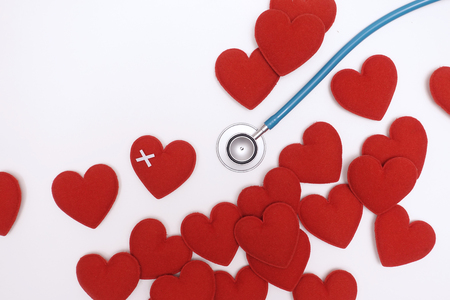 Red heart with stethoscope isolated on white backgroundの写真素材