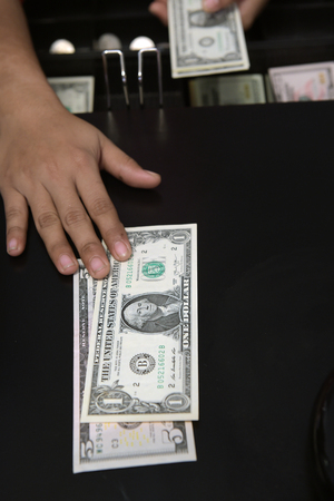 High angle view of cashier searching for change in cashの写真素材