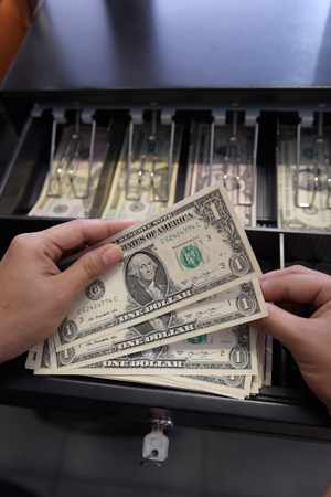 High angle view of cashier searching for change in cash