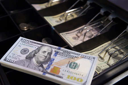 High angle view of cashier searching for change in cash
