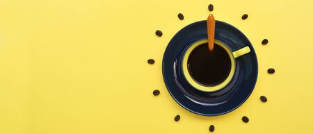 Close up of cup of coffee on yellow backgroundの写真素材