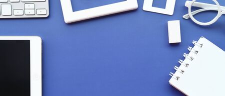 Top view of office desk table with keyboard, notebook, pencil and mouse for backgroundの写真素材