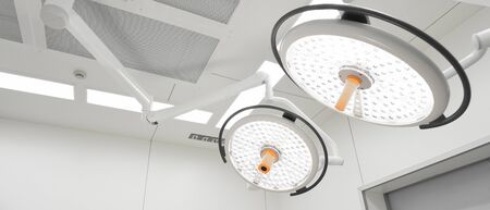 Two surgical lamps in operation room take with selective color technique and art lightingの写真素材