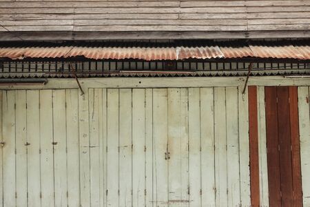 vintage wooden door on facade of old building in Thailandの写真素材