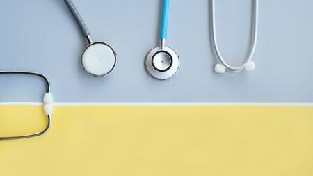 close up of stethoscope on gray and yellow backgroundの写真素材