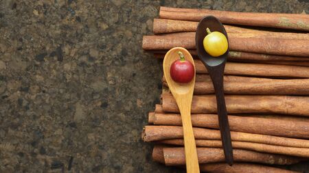 fresh coffee bean on wooden spoon and cinnamon on wooden background