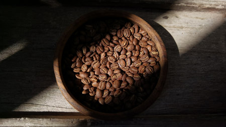 Close up of coffee beans in wooden bowl for backgroundの写真素材