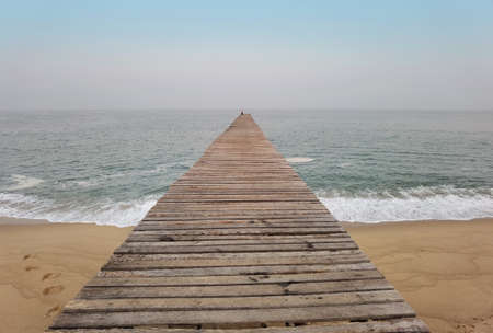 Close up of wooden bridge to the sea with a beautiful sea