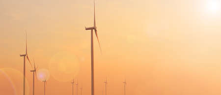 Windmills for electric power production at sunset