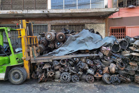 The recycle garage sale about old car wheel axles and parts of car