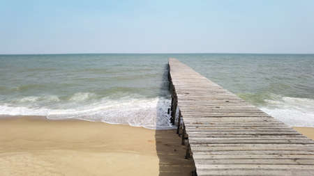 Close up of wooden bridge to the sea with a beautiful seaの写真素材