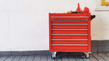 Red plastic oil funnel on steel locker at the repair garageの写真素材