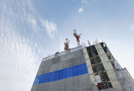 construction of buildings and a crane on blue sky background