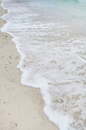 Wave of the sea on the sand beachの写真素材
