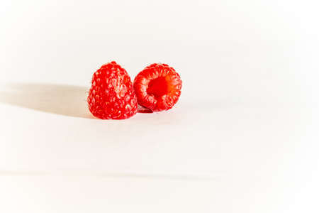 Raspberries, two berries, red, scarlet, ripe, close-up, horizontal, food and drinks, white backgroundの写真素材