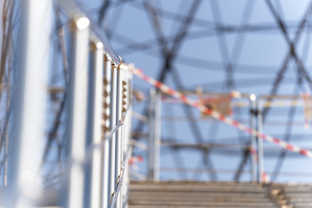 Fence, stair railing, metal, round, hold on, walk, steps up, no people, passage closed, day, sun, background blurred, abstraction, territory free of COVID-19の写真素材