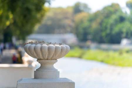 Large flower decorative vase on a blurry background of the urban environmentの写真素材