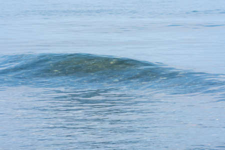 07_ Small blue sea waves near the shore on a sunny day