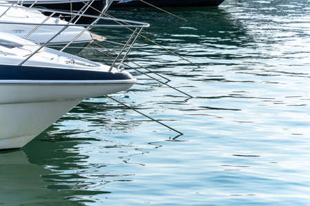 A fragment of the bow with the handrails of white yachts standing at the pier. Lifestyle. Tourism and travelの写真素材