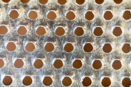 View of the sharp holes in the stainless steel grater for grinding productsの写真素材