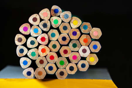 View of a set of several non-sharpened pencils of different colors arranged horizontally on a stack...