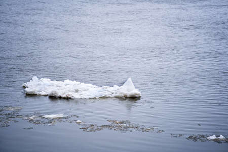 An ice floe floats on the river
