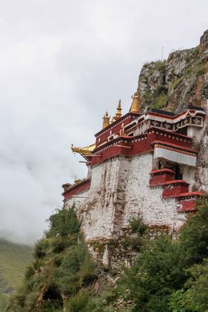 Drak Yerpa view on the valley with woman tourist standing and spreading her armsの写真素材