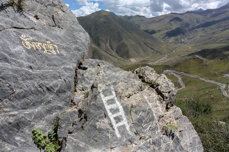 Painted white ladder rocks on a hiking trail around Drepung monastery near Lhasa, Tibet, Asiaの写真素材