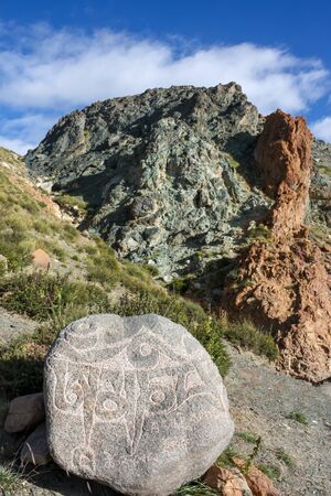 Carved colurful rocks on trekking kora around mountain Kailash Day 1 pilgrimage route near Darchen, Tibet, Asiaの写真素材