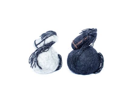 White and black horses made of wool felt lookingの写真素材