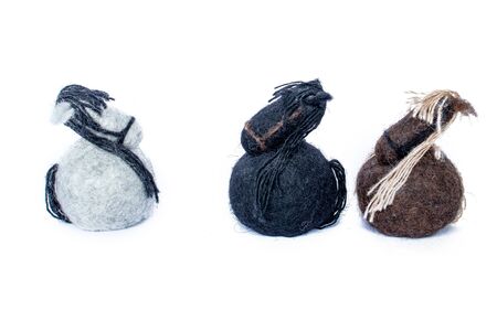 White horse oposing black and brown horses handmade of wool feltの写真素材
