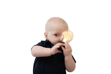 Baby boy portrait and glowing light bulb hiding behindの写真素材