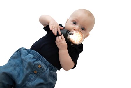 Baby boy portrait and glowing light bulb suckingの写真素材