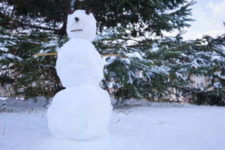 Snowman on the background of the Christmas tree. Russian Winterの写真素材