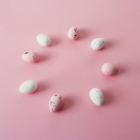 Pink and white easter eggs, quail, circle frame.