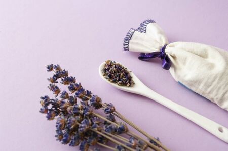 Lavender dry flowers , ceramic spoon with herbals, fabric bag sachet. Relaxing.の写真素材
