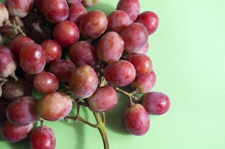 grape bunch close up, fresh fruit photo. green background copy space.