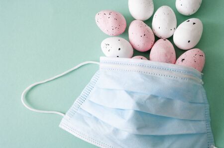 Easter quarantine concept. Protection mask , colorful eggs, health care.の写真素材