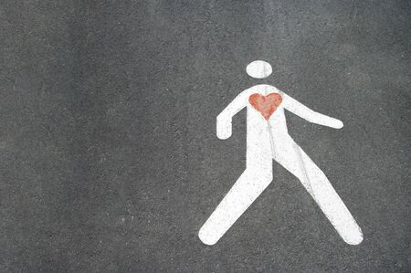 White painted sign man with red heart indicating pedestrian lanes. Copy space,text.の写真素材