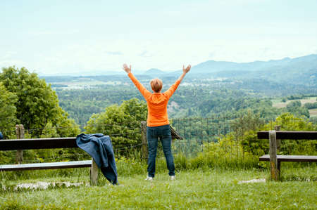Vintgar, Slovenia - 24 may 2020: Vintgar gore, Slovenia. Hiking in national park.Woman put hands up, doing exercises outdoorsのeditorial素材