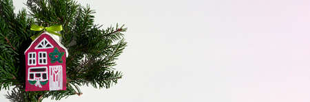 Christmas banner with red wooden house and spruce branches, colorful, gift ideas. diy. Handmade decor. Good web design for real estate agency.の写真素材