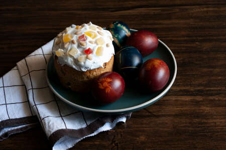 Easter 2021 holiday, eggs and bakery in ceramic plate on wooden table. Traditional food