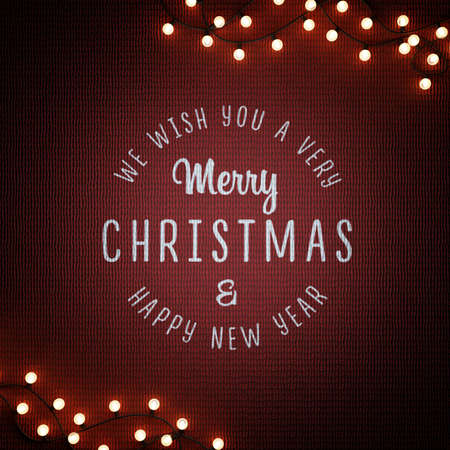 Christmas garland on a dark red knitted background. Square Christmas card.の写真素材