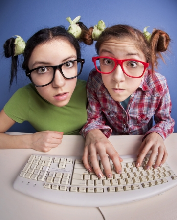 Twin sisters at the computer の写真素材