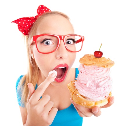 Funny girl eating a cream puffの写真素材