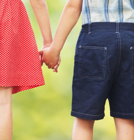 Children holding hands, first love or siblings concept の写真素材