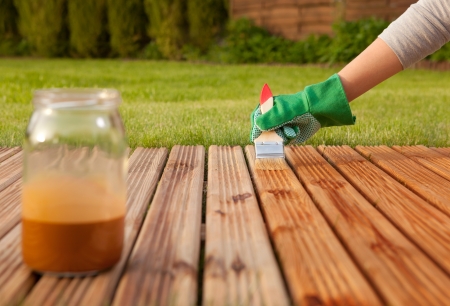 Applying protective varnish on a patio wooden floorの写真素材